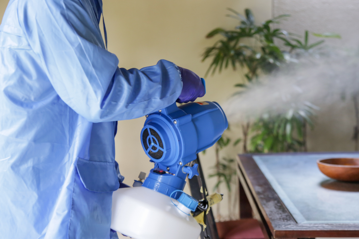 Professional disinfection service using a fogging machine to sanitize and deodorize indoor spaces. Technician in protective gear ensuring a safe and thorough application, provided by NSH Home Services.