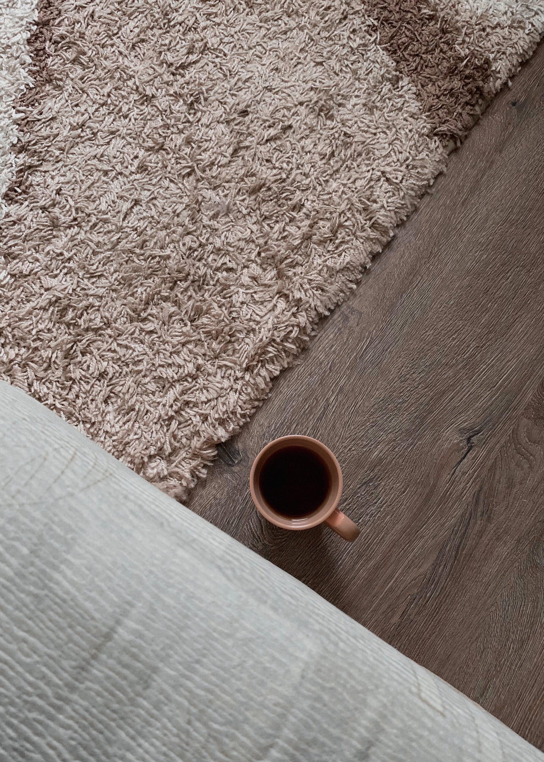 coffee mug next a clean rug