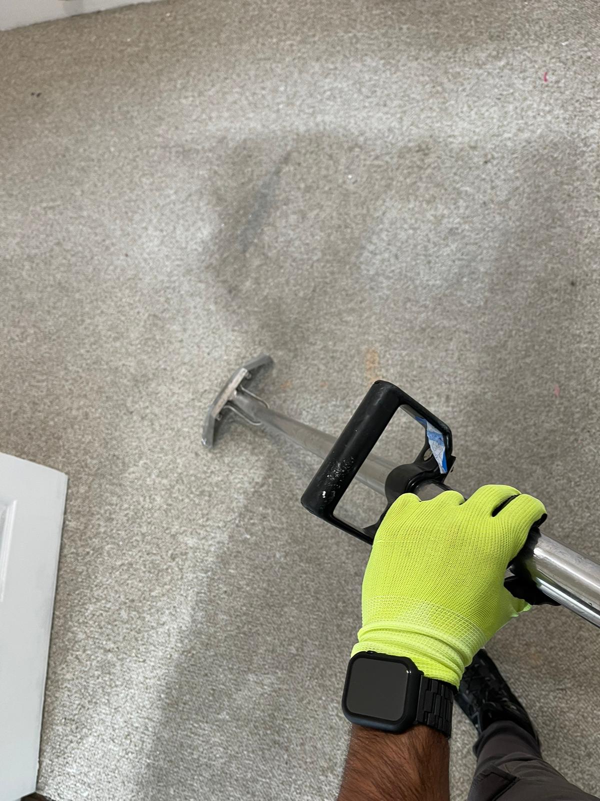 A professional technician from NSH Home Services uses a high-powered carpet cleaning tool to restore and refresh a light gray carpet. The visible difference between cleaned and uncleaned areas highlights the effectiveness of our deep carpet cleaning services. Our skilled team ensures a thorough clean, removing dirt, stains, and allergens to improve the appearance and hygiene of your home’s carpets